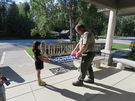IMG 5927  Megan and Ranger folding the American Flag, Denali National Park Visitor Center, Talkeetna, AK