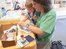 IMG 5936  Phelan and Mommy, stamping National Park Passport book, Denali National Park Visitor Center, Talkeetna, AK