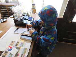 IMG 6624  Megan stamping her National Parks Passport, Wrangell-St. Elias National Park Visitor Center, AK