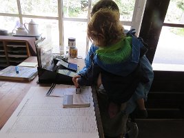 IMG 6625  Megan and Phelan stamping National Park Pass, Wrangell-St. Elias National Park Visitor Center, AK